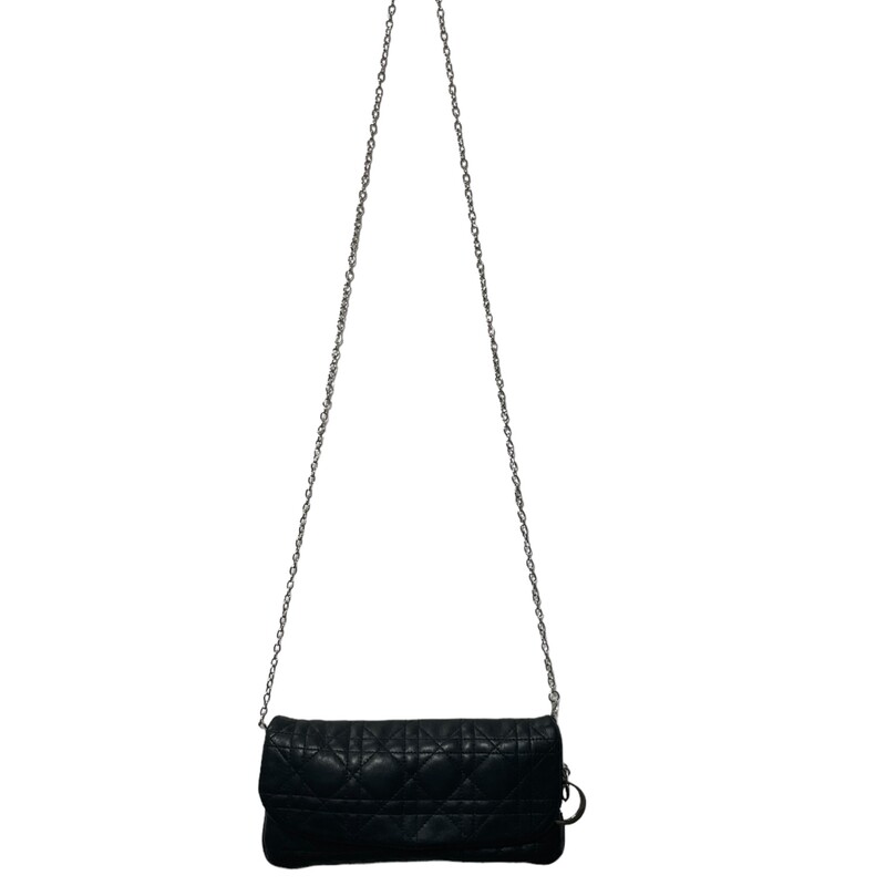 CHRISTIAN DIOR Cannage Quilted Cross Body Bag in Black. This stylish cross-body bag is crafted of geometric quilted cannage leather. The bag features a silver cross-body chain link strap and a facing flap that opens to a satin interior with room enough for day or evening essentials with the classic chic only from Christian Dior!

Dimensions: 8.5W x 5H x 1D
22 strap drop