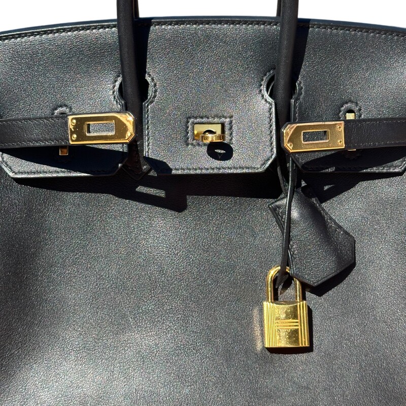 HERMES Birkin Togo Black
This stunning Birkin handbag is crafted of textured calfskin togo leather in black. The luxurious handbag features looping leather top handles, a cross-over flap, and a strap closure with palladium silver plated hardware links with a polished padlock including a hanging clochette with keys. The flap opens to a matching chevre leather interior with zipper and patch pockets

Production year: 2017

Size 25
Dimensions:
Base length: 10 in
Height: 7.75 in
Width: 5 in
Drop: 2.5 in

Comes With box, bag, raincoat and keys.
Some minor corner wear see pics for reference
