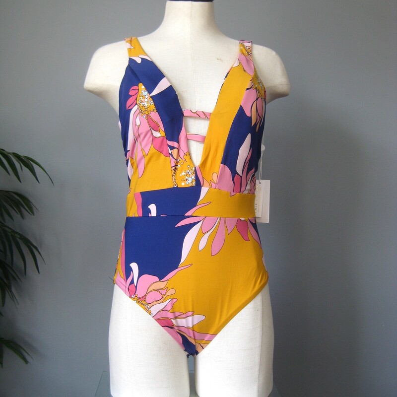 Gorgeous one piece swimsuit from Trina Turk<br />
Yellow and Purple splashy Pucci-esque print<br />
Plunging neckline<br />
size 10<br />
brand new never worn.<br />
<br />
thanks for looking!<br />
#69185