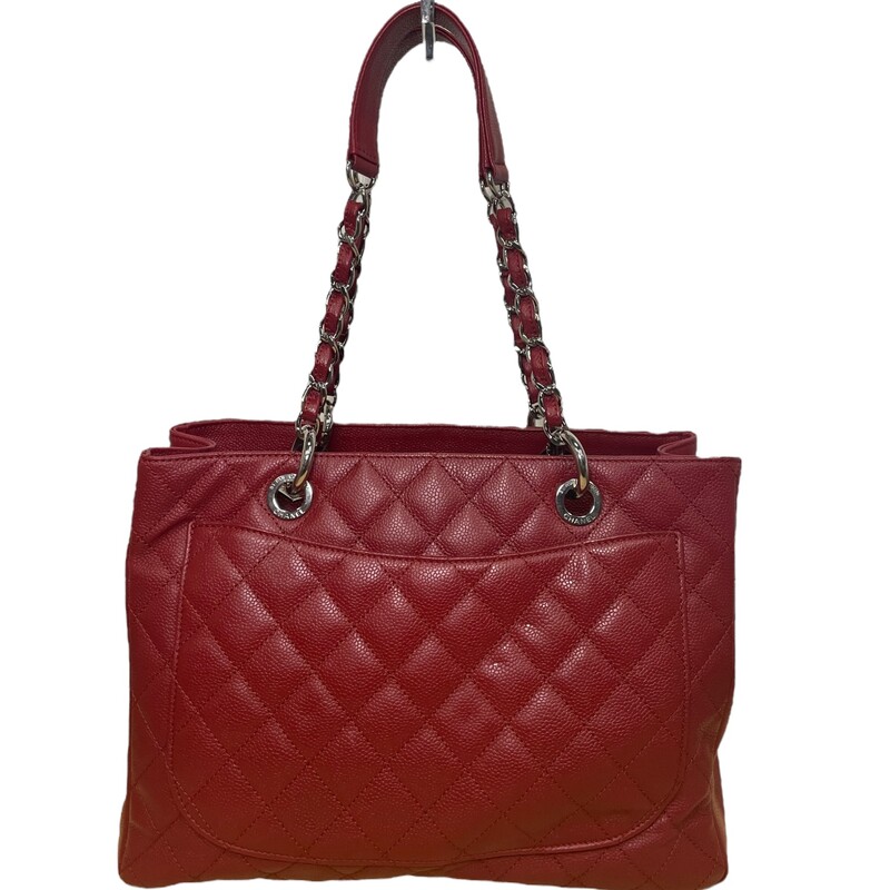 Chanel Red Caviar Leather Grand Shopping Tote. The Grand Shopping Tote features a quilted caviar leather body, silver-tone hardware, an exterior back pocket, and dual chain-link and leather shoulder straps.<br />
In Excellent Shape<br />
Dimesnsions: 13 L x 9.5 H x 6.5 D, 10 handle drop.