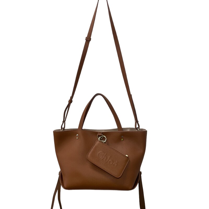 Chloe Sense East West  2023<br />
Tan leather and gold-tone hardware give this tote a classic yet modern feel, complemented by a logo-embroidered removable small zippered purse.<br />
Dimensions:<br />
13 inches wide<br />
7.5 inches high,<br />
 5.5 inches deep,