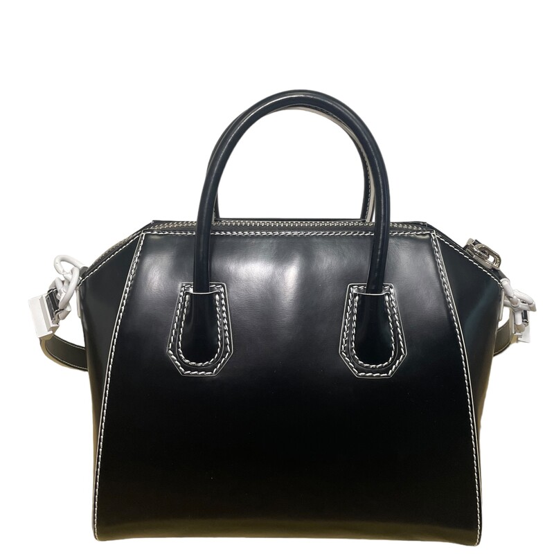 Givenchy Antigona Smooth Contrast<br />
<br />
Size: Small<br />
<br />
Dimensions:<br />
9H x 10.5W x 6.5D.<br />
Rolled tote handles, 3.5 drop.<br />
Flat shoulder strap, 13.4 drop.<br />
<br />
Givenchy shiny calfskin satchel bag with shiny palladium hardware.<br />
<br />
Extended zip top closure.<br />
Envelope flap detail with metal logo lettering.<br />
Interior, cotton lining; one zip pocket and two open pockets.<br />
Feet protect bottom of bag.<br />
<br />
Antigona is made in Italy.