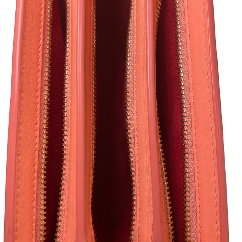 Christian Louboutin 2016 Triloubi Large Spiked shoulder bag in capucine leather featuring gold-tone hardware. The design features three zipper compartments and is lined in red alcantara with one open pocket against the back.
Dimensions:
Height:  7.2in
Width: 9.9in
Depth 2.9in
Drop of the Handle 12.1in