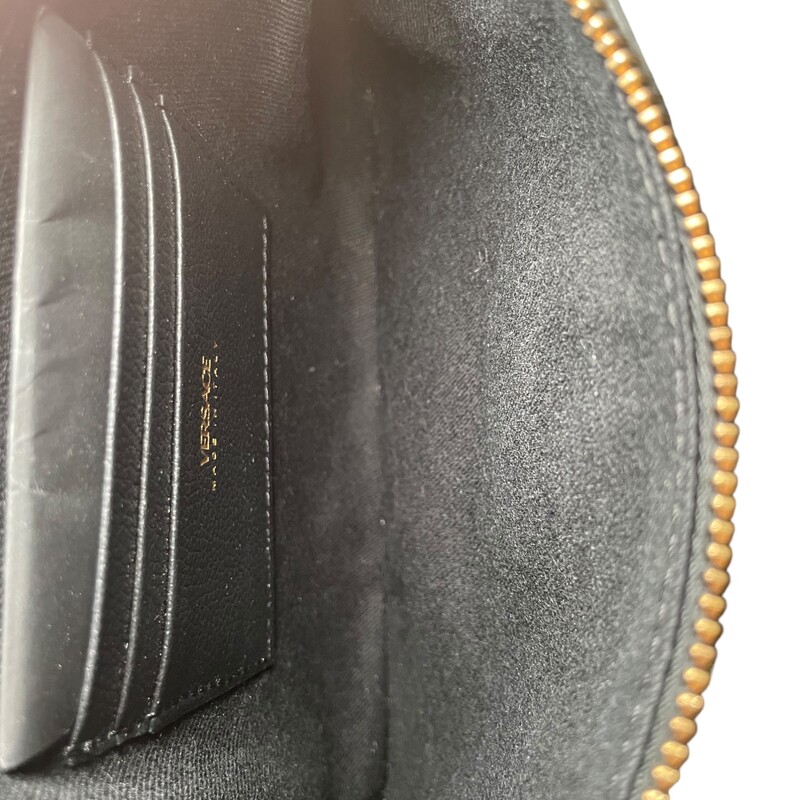 Versace Medusa Wristlet
Versace Clutch
Black Leather
Gold-Tone Hardware
Wrist Strap
Single Exterior Pocket
Canvas Lining with Card Slots
Zip Closure at Top

Dimensions:
 Height: 6.25
Width: 9
Depth: 0.25