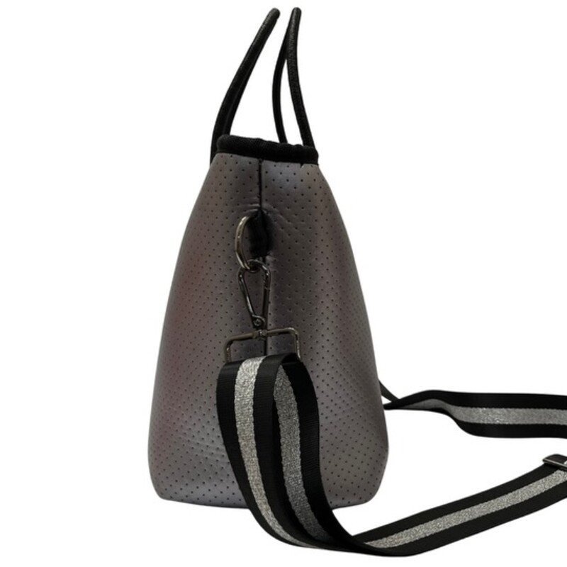 Haute Shore Grayson Tote Handbag and Wristlet<br />
<br />
This neoprene compact zip-top tote goes from day to night with its streamline design<br />
Top handles and removable crossbody strap.<br />
Lined interior with zip pocket and removable wristlet pouch<br />
Dimensions- 10 inches wide x 7.5 inches tall x 5.5 inches<br />
Colors: Silver and Black