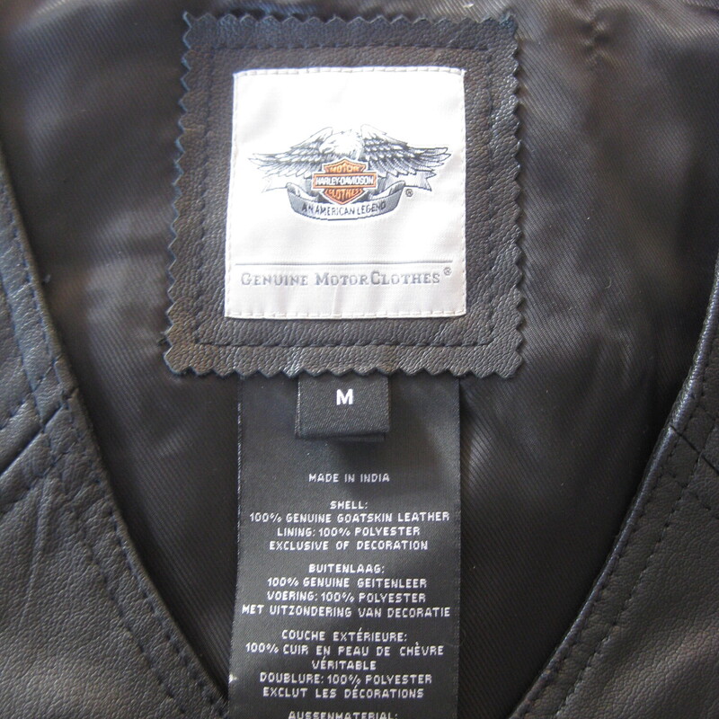 No frills black leather riding vest by<br />
Harley-Davidson<br />
fully lined<br />
snap front<br />
marked size M (seems a little small for a modern size Medium gal, esp if busty<br />
Flat measurements:<br />
armpit to armpit: 18.75<br />
width at hem: 19.75<br />
length: 23<br />
<br />
perfect condtion.<br />
<br />
thanks for looking!<br />
#69164