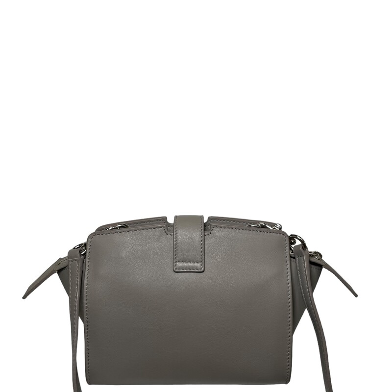 Saint Laurent Calfskin Monogram Toy Cabas in Oyster Grey. This stylish tote is crafted of soft smooth calfskin leather in grey. The handbag boasts the versatility of an optional shoulder strap and a crossover strap adorned with a sleek, weighted YSL charm in polished silver. The top effortlessly unzips to reveal a neatly arranged interior in matching leather, complete with convenient card slots.<br />
Code: GNR452322-1116<br />
Year: 2016<br />
Dimensions: 6.25 x 5 x 3.5 in