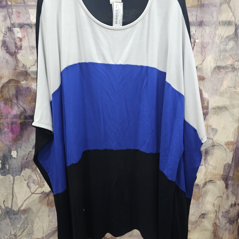Poncho style top in black white and blue with solid black panel in back. Slit style arm holes.