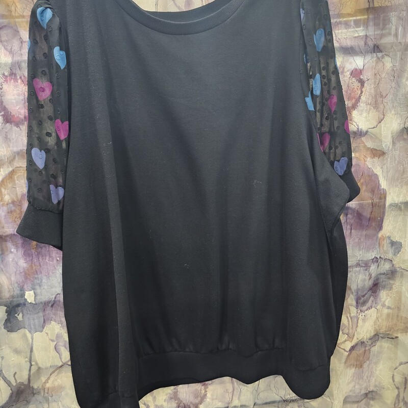Such a cute short sleeve knit top in black with sheer sleeves and hearts.