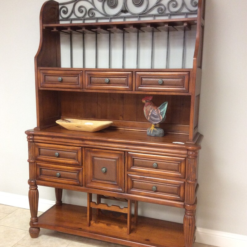 This is a very nice wine buffet hutch, a combination of metal and wood. It provides plenty of storage, has a dark wood finish and several drawers.