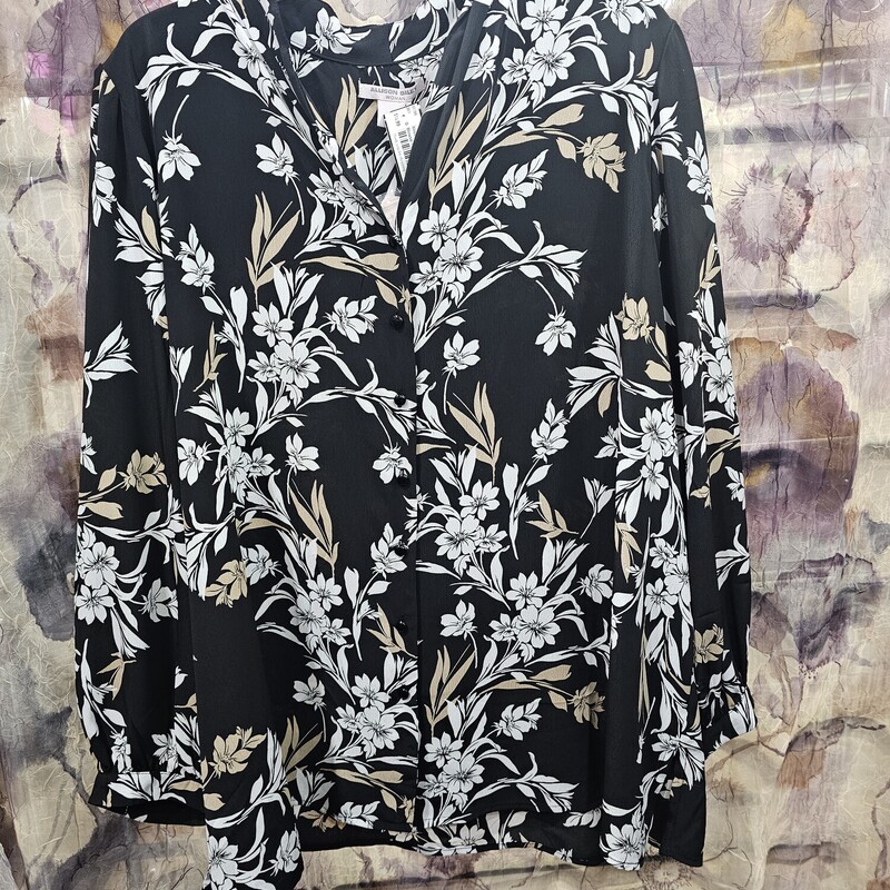 Brand new with tags, this blouse is black with a white and beige floral pattern.
