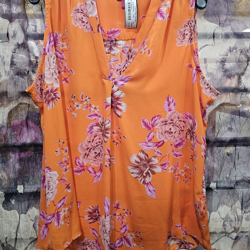 Sleeveless blouse in a neon orange with magenta and pink floral design.