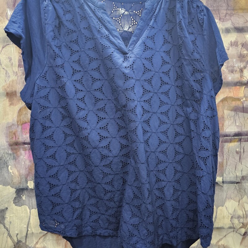 Cute short sleeve blouse in blue with die cut pattern on front panel.