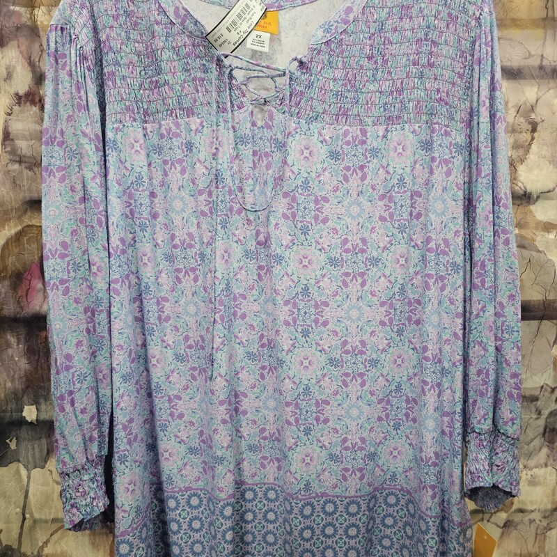 Brand new with tags and retails for $65. Boho style blouse in purples and blue floral print with tie at the neck.