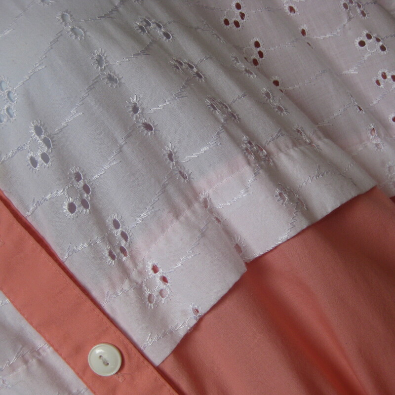 Shirt dress from the 1960s in a peach cotton poly blend.<br />
The top has short sleeves and a white eyelet inset detail.<br />
The waist is elasticized<br />
The skirt is quite full and has another eyelet inset.<br />
Pretty summery peach color.<br />
Unlined<br />
Buttons to the waist.<br />
Sash belt<br />
by Bridge Gate<br />
made in Taiwan<br />
<br />
This dress could fit a modern size 3X, pls use thhe measurements provided as your ultimate guide to fit.<br />
Flat measurements:<br />
armpit to armpit: aprox 44<br />
Waist: 20.5 stretches comfortabley to 24<br />
Hip: 29<br />
Length: 47<br />
<br />
Excellent condition.<br />
<br />
Thanks for looking!<br />
#3784