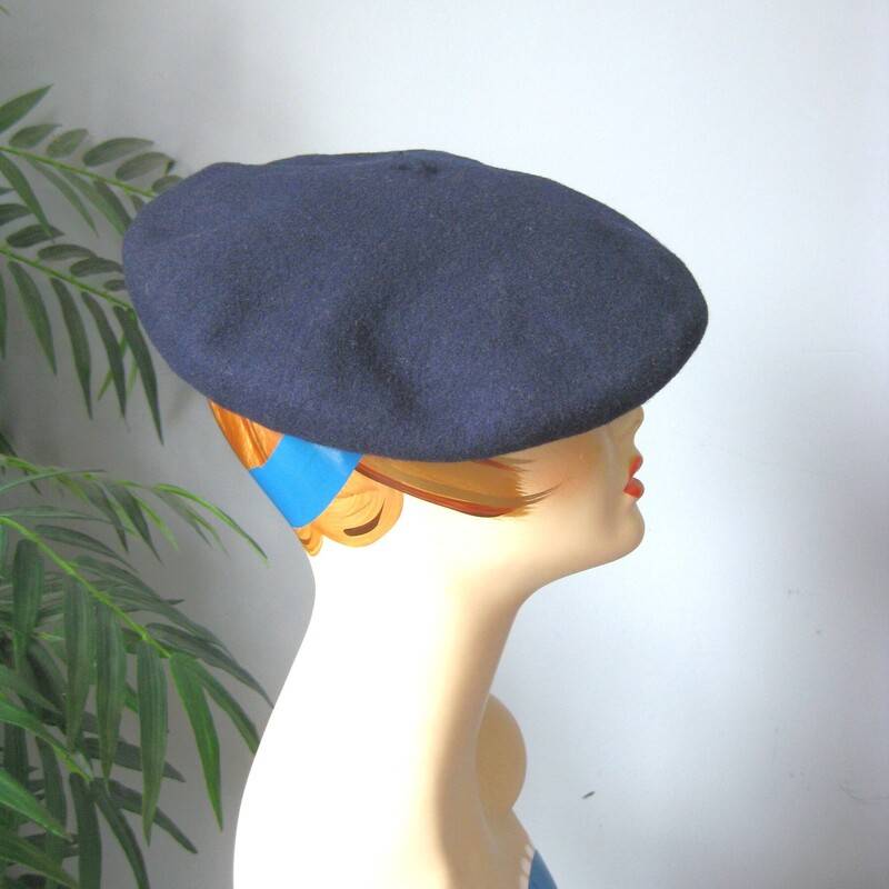 Darling vintage navy blue wool beret<br />
these look so chic perched on your head and it is easy to style in different ways by changing the position on the head<br />
This one is 100% wool, made and sold in Madrid Spain.<br />
It has a leather interior hat band which is cracked in multiple places but doesn't affect the wearing and the outside is in excellent condition.<br />
It measures 21 around on the inside.<br />
<br />
<br />
Thanks for looking!<br />
 #50743