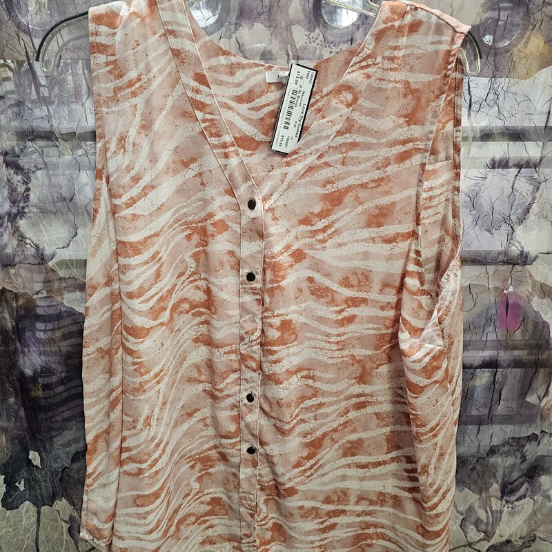 Sleeveless blouse with button up front in an off white and burnt orange pattern.