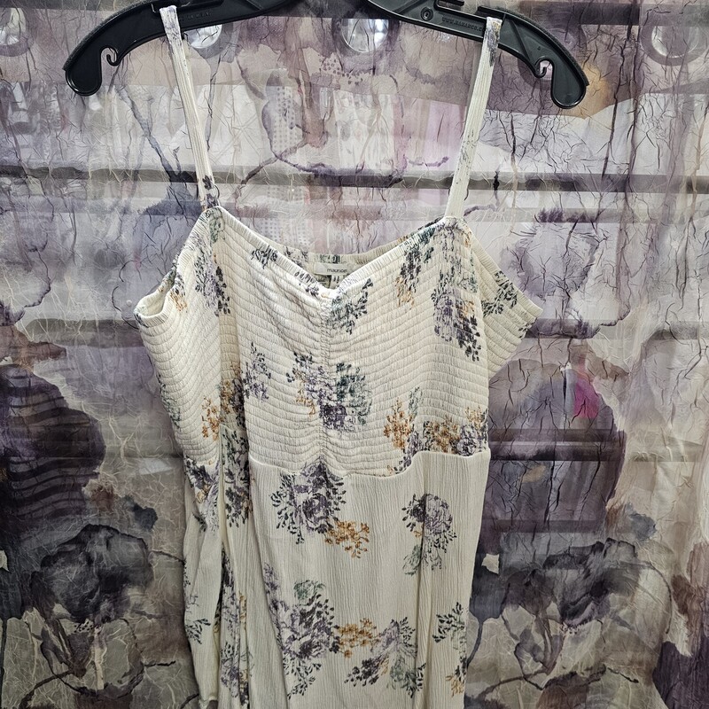 Tank top in an off white with floral design, adjustable straps and baby doll style fit