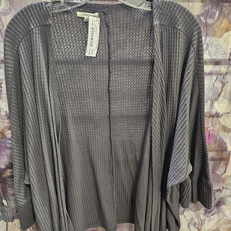 No close front waist length duster in a grey waffle material with ruffled sleeves