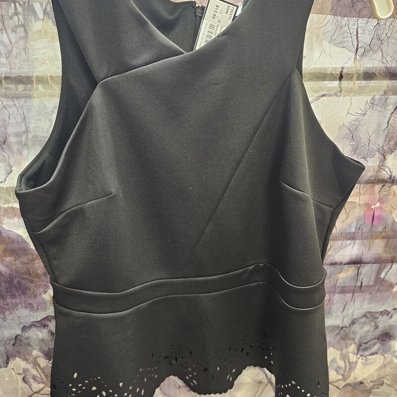 Sleeveless blouse in black, form fitting with die cut design.