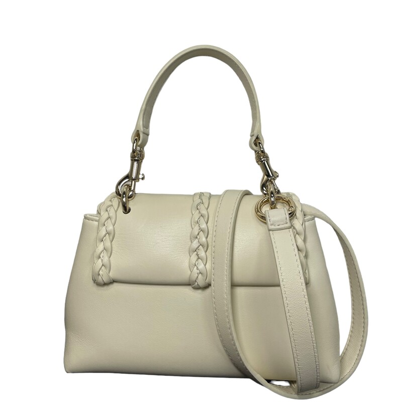 Chloe Penelope Soft Cream

Size: Mini

Dimensions:
5 1/2H x 9W x 3 1/2D. (Interior capacity: small.)
4 1/2 strap drop
19 strap drop
1.80lbs

Braiding and tassels bring Chloé's signature equestrian aesthetic to this softly structured satchel shaped from supple calfskin leather. This compact version comes with both a removable handle and crossbody strap for more carry options.