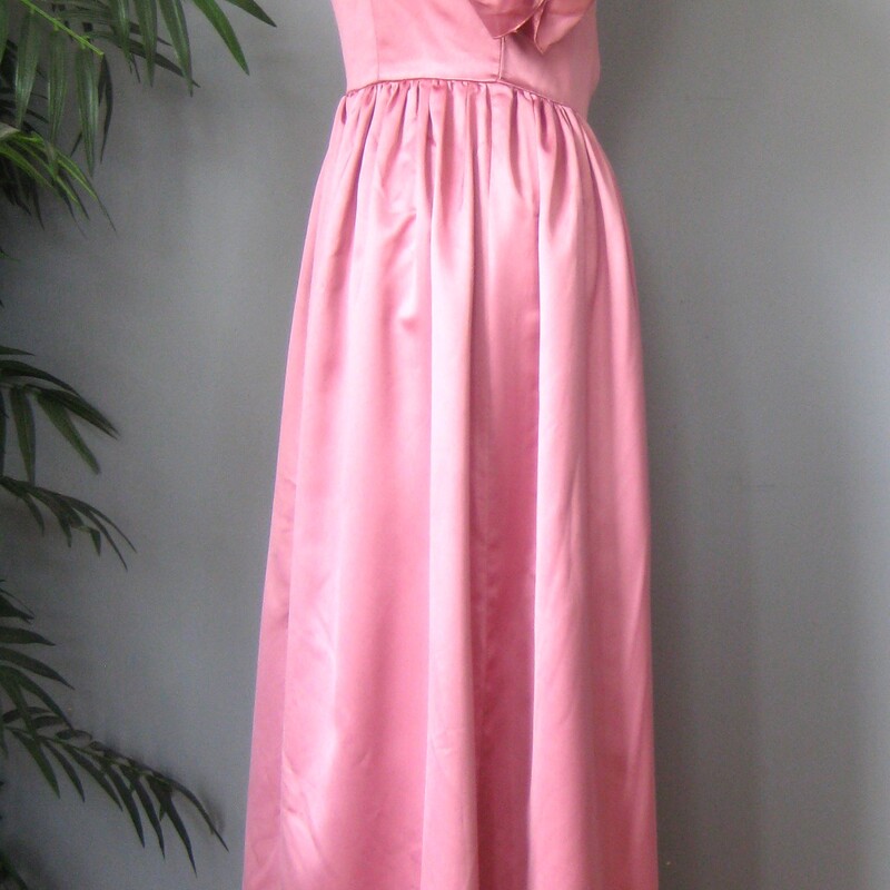 Vtg Satin Gown, Pink, Size: Medium<br />
Amazing gown in pink satin.<br />
The main feature are the pretty puffy full sleeves with rosettes.<br />
The tops of the sleeves are elasticized, so you could experiment with wearing this off the shoulders.<br />
Sweetheart neckline<br />
Simple but full gathered skirt - add a crinoline for extra fullness.<br />
center back zipper<br />
Excellent vintage condition, a couple of very small spots.<br />
<br />
No tags - possibly handmade<br />
Flat measurements, please double where appropriate:<br />
armpit to armpit: 17<br />
waist: 14.5<br />
hip: 25.5<br />
length: 54 (in the back)<br />
<br />
Thanks for looking!<br />
#56939
