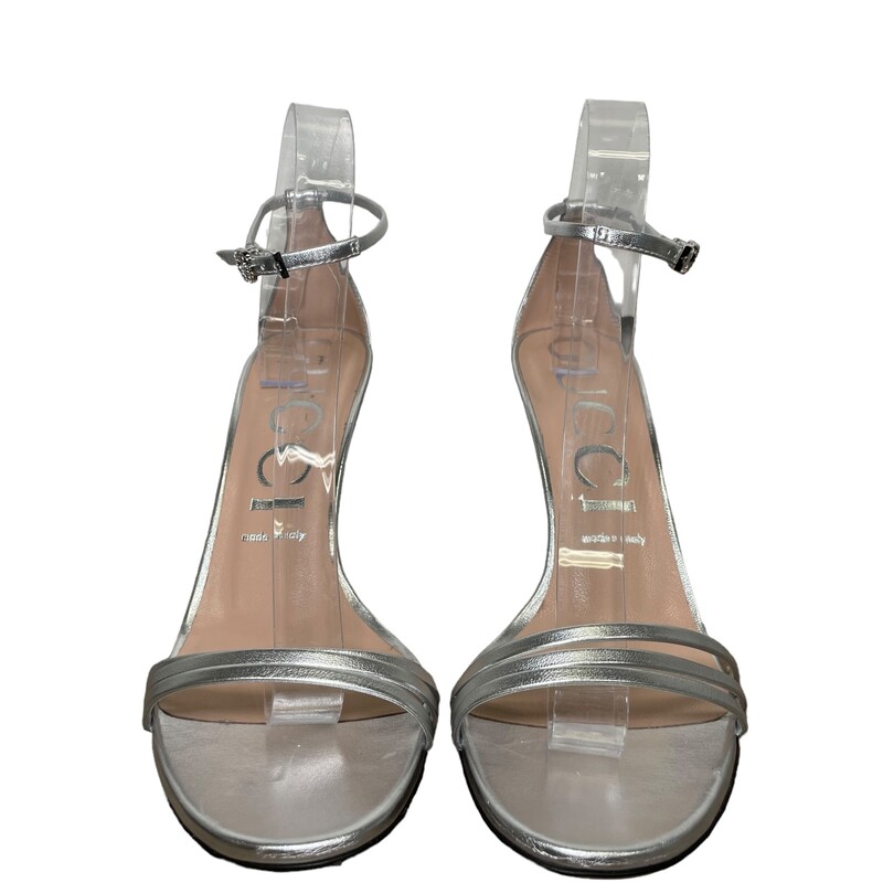Gucci Metallic Sandal
Size: 39
Style:551213 B8B00 8106

Crafted in metallic silver leather, the high-heel sandal sports a subtle design with a thin heel and three front straps. A delicate crystal Double G buckle embellishes the ankle strap.

Metallic silver leather
Women's
Ankle strap with metal Double G buckle with crystals
High heel
4.5 heel height
Made in Italy