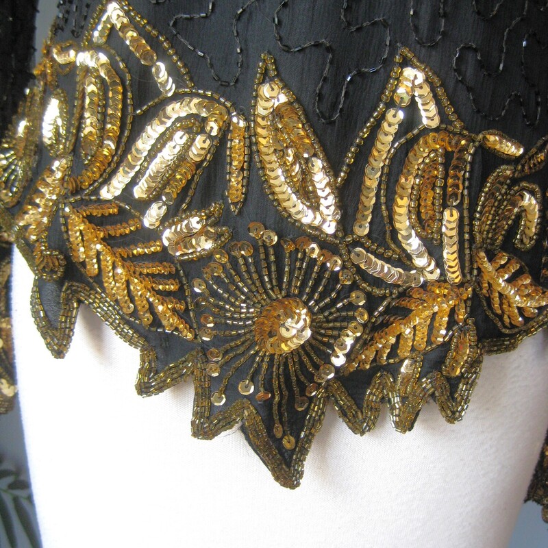 Vtg Law. Kazar Bead Silk, Black, Size: L<br />
black and gold sequined top for special ocassions<br />
by<br />
Lawrence Kazar<br />
<br />
gorgeous shaped silhouette, long sleeves,<br />
silk shell<br />
made in India<br />
short sleeves<br />
shoulder pads<br />
fullly lined<br />
long zipper in the back<br />
Flat measurements:<br />
shoulder to shoulder: 18<br />
armpit to armpit: 20.25<br />
waist area: 15.5<br />
length: 22.3<br />
underarm sleeve seam: 23<br />
sleeve from edge of shoulder pads to end: 23<br />
excellent condition, no flaws.<br />
<br />
thanks for looking!<br />
#1933