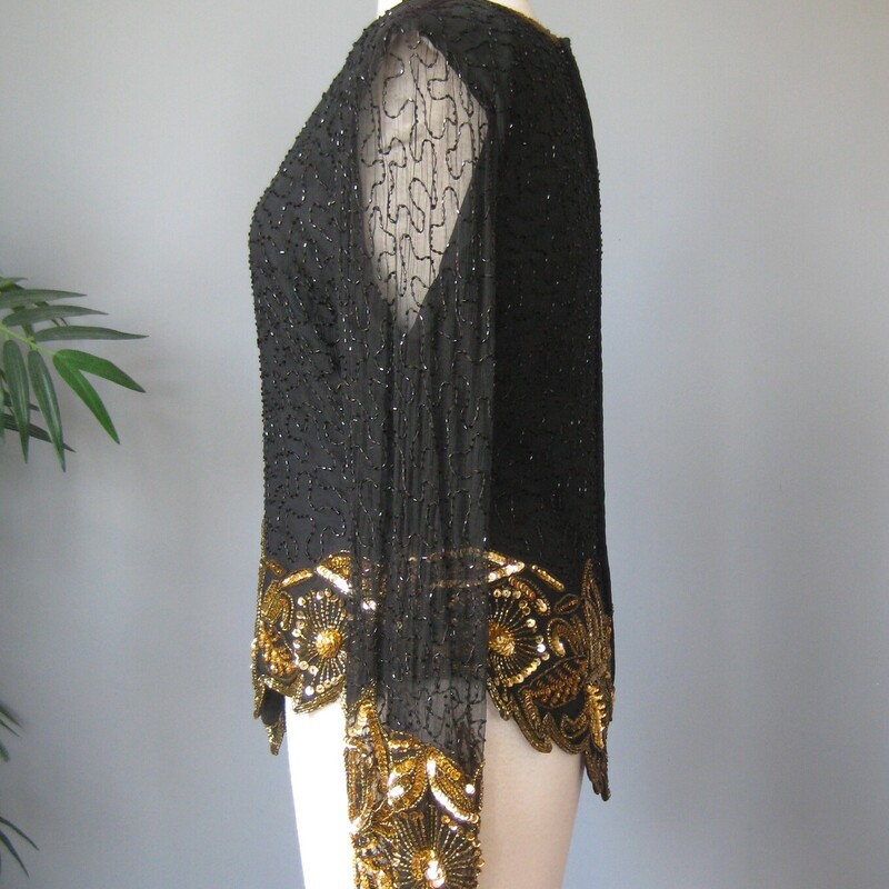 Vtg Law. Kazar Bead Silk, Black, Size: L<br />
black and gold sequined top for special ocassions<br />
by<br />
Lawrence Kazar<br />
<br />
gorgeous shaped silhouette, long sleeves,<br />
silk shell<br />
made in India<br />
short sleeves<br />
shoulder pads<br />
fullly lined<br />
long zipper in the back<br />
Flat measurements:<br />
shoulder to shoulder: 18<br />
armpit to armpit: 20.25<br />
waist area: 15.5<br />
length: 22.3<br />
underarm sleeve seam: 23<br />
sleeve from edge of shoulder pads to end: 23<br />
excellent condition, no flaws.<br />
<br />
thanks for looking!<br />
#1933