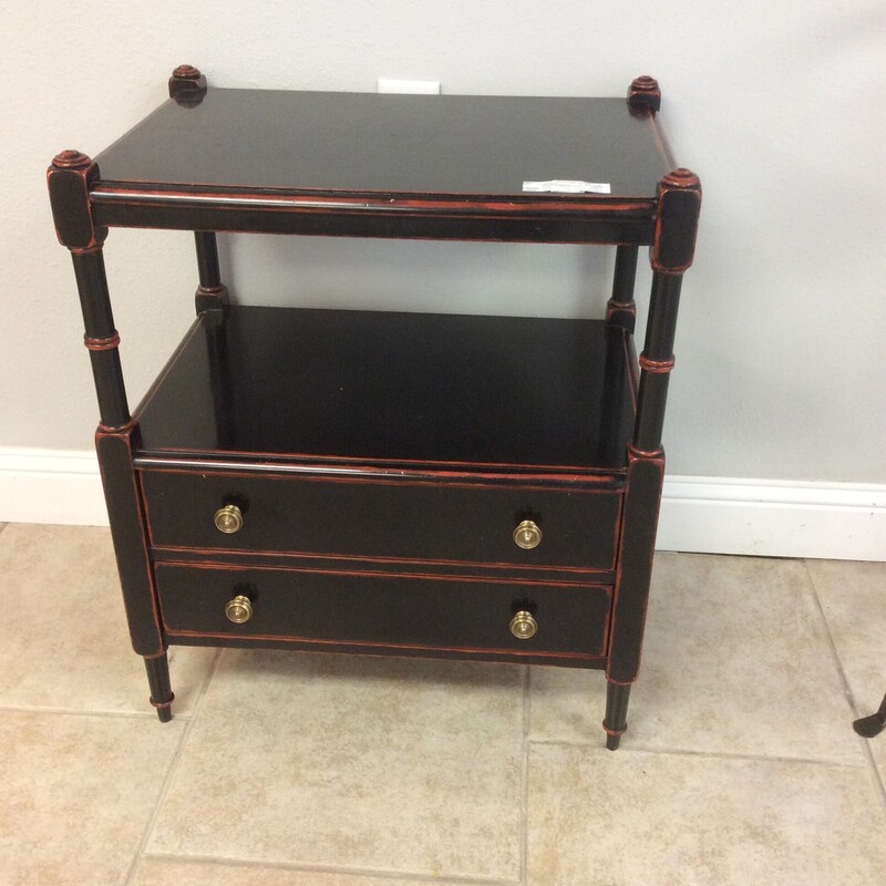 This chic little side table by Designer Theo Alexander has a black distressed finish with a red under coat.
