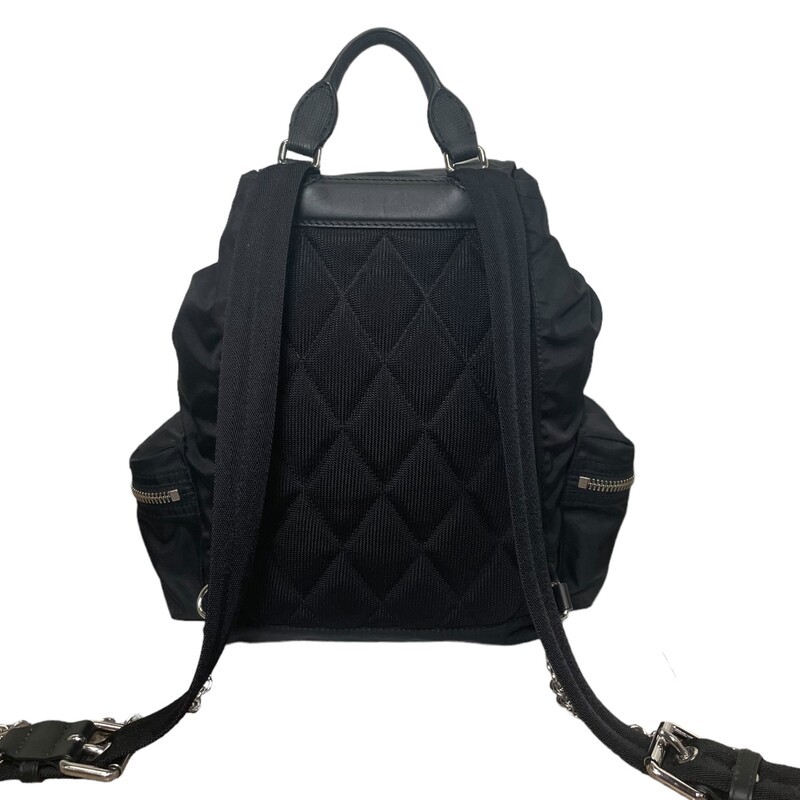 Burberry Nylon Black Rucksack

Dimensions:
Base length: 11 in
Height: 13 in
Width: 5 in
Drop: 3 in
Drop: 19 in

This is an authentic BURBERRY Nylon Medium Crossbody Rucksack Backpack in Black. This chic backpack is crafted of quilted nylon in black. The bag features adjustable black nylon shoulder straps, a front zipper pocket, two side zipper pockets, and black leather trim including a rolled leather top handle, and polished silver hardware. This backpack opens to a black fabric interior with a patch pocket.