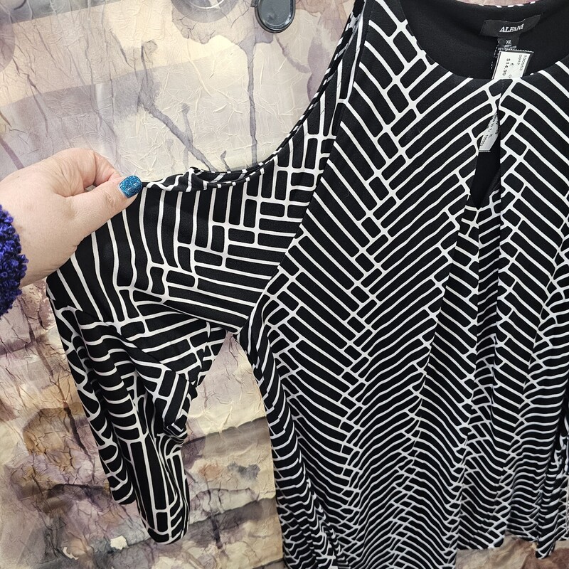 Brand new with tags, this blouse is cold shoulder style in a black and white stripe  and half sleeve length