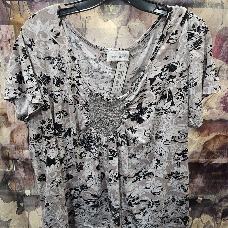 Short sleeve knit top in light tan with black and white print.