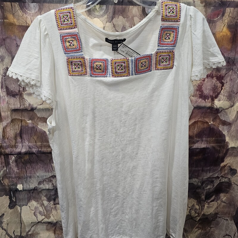 Brand new with tags and retails for $60!  This is a short sleeve white knit top with embroidered design along the neck.