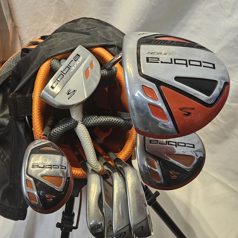 Cobra Jr 7 Piece Golf Club Set
Size: Jr
Age: 9 - 12
Height: 53in +
Graphite Shafts w/ Junior Regular Flex
Condition: Pre-Owned Like New

Set Includes:
- Driver
        - Forgiving, 375cc Head
        - Higher Lofted, Fast Launching Design
        - Lightweight, Junior-Flex Shaft and Junior-Sized                   Grip
        - Cobra Cap Driver Head Cover High End PU            Leather
- Fairway Wood & Hybrid
        - Low Center of Gravity for Easy Ball Flight
        - Lightweight , Junior-Flex Shaft and Junior-Sized           Grip
        - Stainless Steel Construction
        - Head Cover for Each
- 7 Iron & 9 Iron
        - Perimeter Weighted for More Forgiveness
        - Lightweight, Junior-Flex Shaft and Junior-Sized           Grip
        - Stainless Steel Construction
- Sand Wedge
        - Perfect for Around the Green
        - Lightweight, Junior-Flex Shaft and Junior-Sized                   Grip
        - Stainless Steel Construction
- Putter
        - Mallet Shape for Easy Alignment
        - Stainless Steel Construction
- Lightweight Stand Bag
        - Premium, Durable Nylon Construction
        - Lightweight Design with 6 Pockets
        - Duel Carry Strap