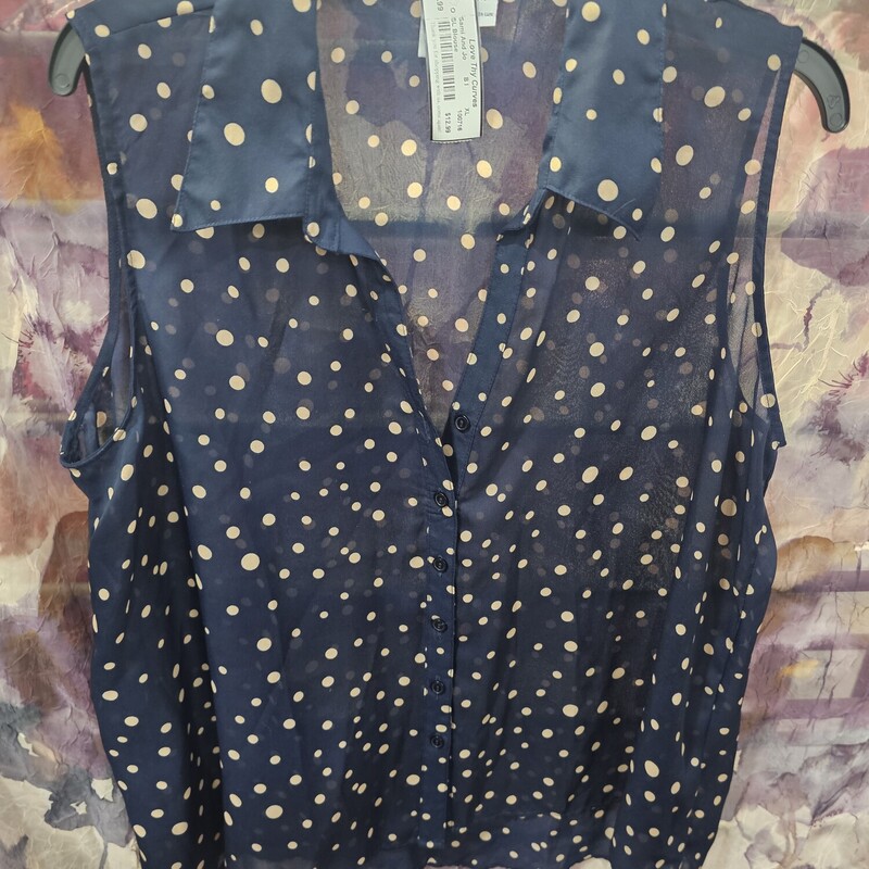 Sleeveless blouse in navy with tan polka dots and button up front.