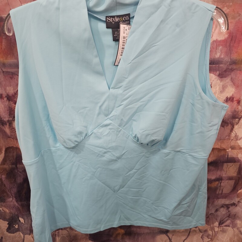 Form fitting sleeveless blouse in a beautiful blue.