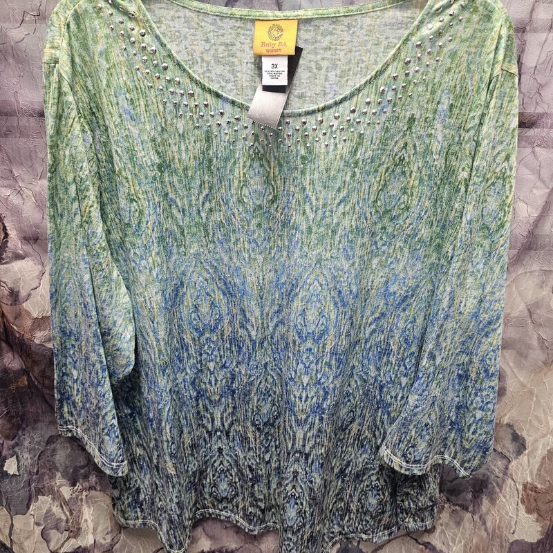 Half sleeve knit top in a green and blue watercolor design with bling on the neckline.