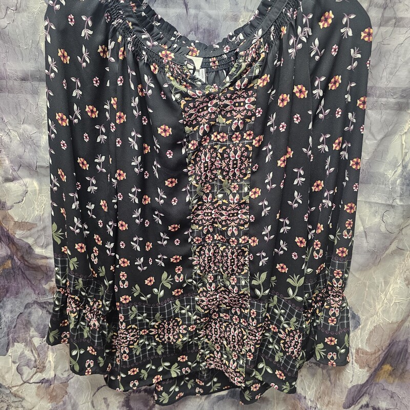 Long sleeve blouse in black with floral pattern.