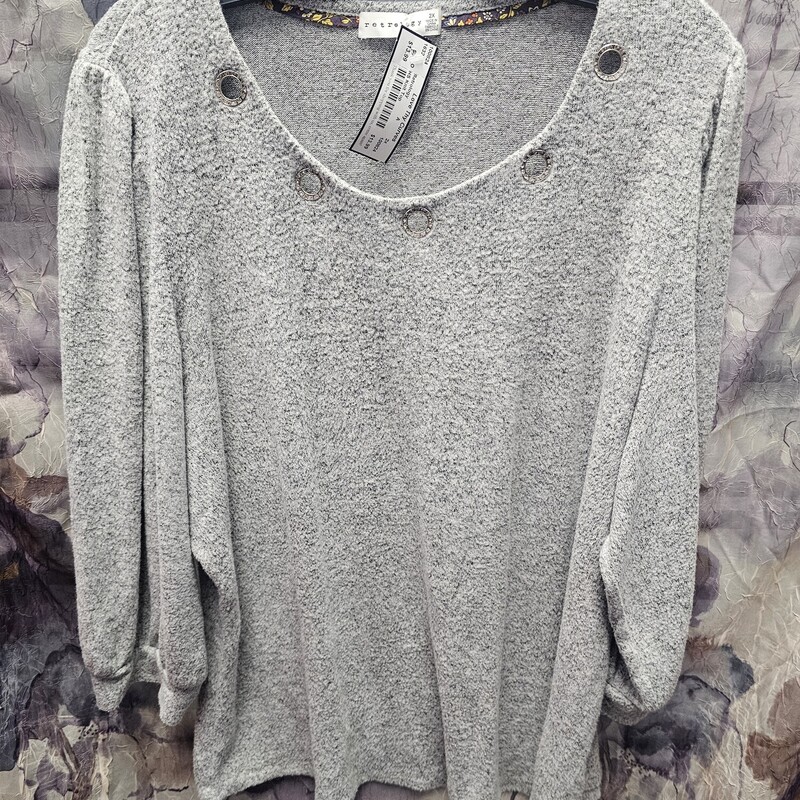 Half to three quarter sleeve sweater style light weight knit top in grey with gromets and bling.
