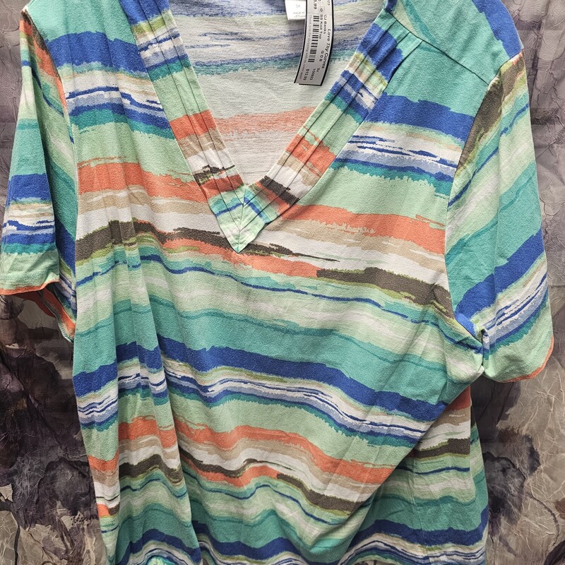 Short sleeve knit top with v neck in blue teal white and orange print.