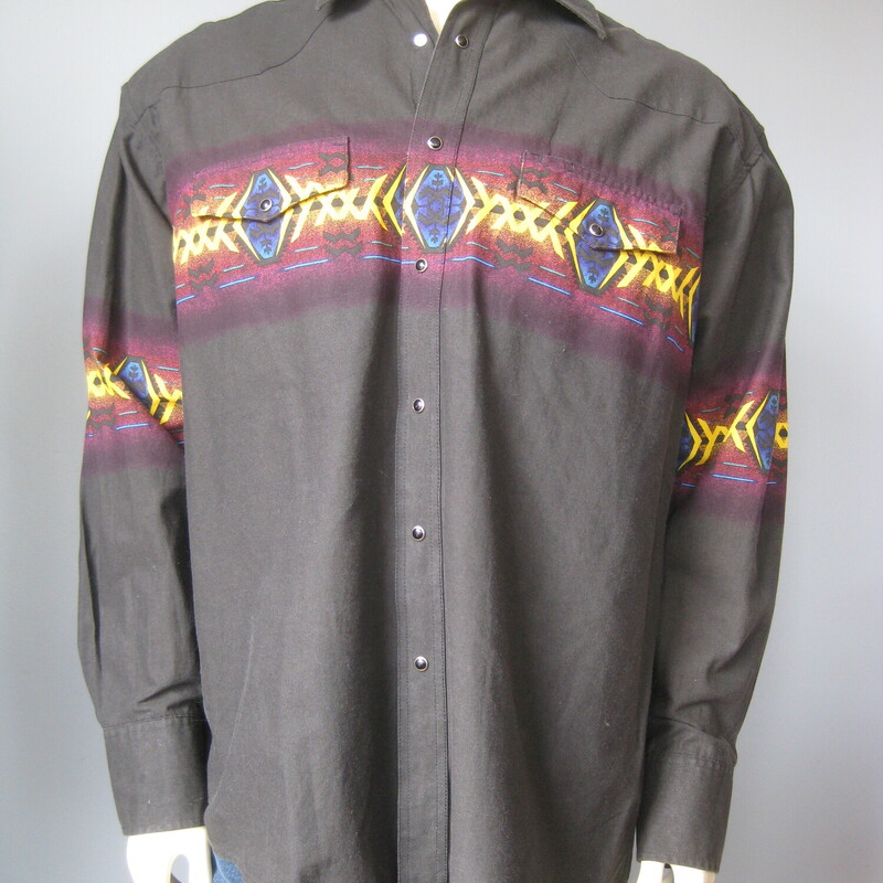 This is a 100% Cotton mens brush popper style shirt by Wrangler
Soft black in color with bright yellow , blue and burgundy southwestern design across the chest and arms.
black pearlized snaps on the front, the cuffs and the two working chest pockets.
Marked size XL

Here are the flat measurements, please double where appropriate:
Shoulder to Shoulder: 22
Armpit to Armpit: 25.5
Underarm sleeve seam length: 21.75
Overall length: 31

excellent conditin, feels crisp like it hasn't been washed yet
Thanks for looking!
#38229