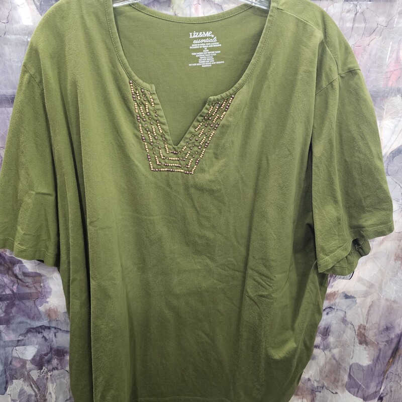 Short sleeve knit top in green with beadwork on the neckline.