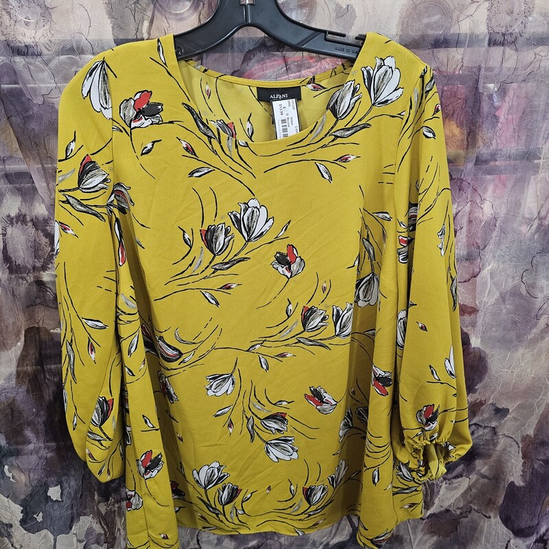Three quarter sleeve blouse in yellow with floral print.
