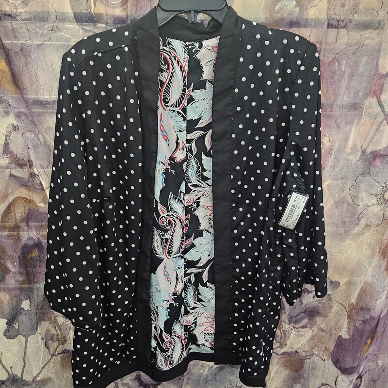 Reversible jacket that matches great with your favorite cami. One side is black with white polka dots, the other is a fun floral pattern on black.