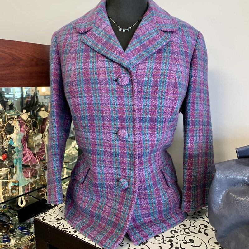 Scottish Tweed Blazer,
Colour: Purple teal blue pink,
Size: 10,
With shorter sleeves,
There is a matching pencil skirt.