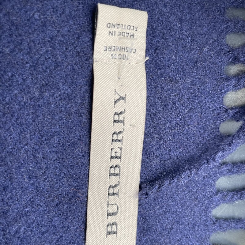 BURBERRY Cashmere Giant Check Fringe Scarf in Blue. The scarf is 100% cashmere in blue with a traditional Burberry check in blue, black and white.<br />
Length: 64.00 in<br />
Height: 12.00 in