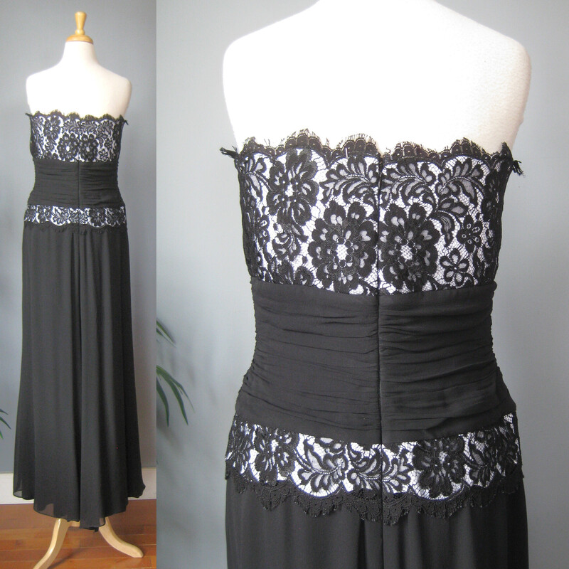 Beautiful black silk gown with lace bodice lined in white<br />
by Tadashi<br />
<br />
The bodice is sheer lace with a white liner from the bust down to the hips, wrapped in a black silk gauze cummerbund.<br />
The skirt is stretchy knit silk gauze and fully lined<br />
<br />
Excellent condition, no flaws found<br />
<br />
Made in the USA , marked size 14<br />
<br />
Armpit to armpit: 17.75<br />
waist: 16<br />
hip: up to 23<br />
length: 53 from mid top line to hem<br />
<br />
Thanks for looking!<br />
#70832