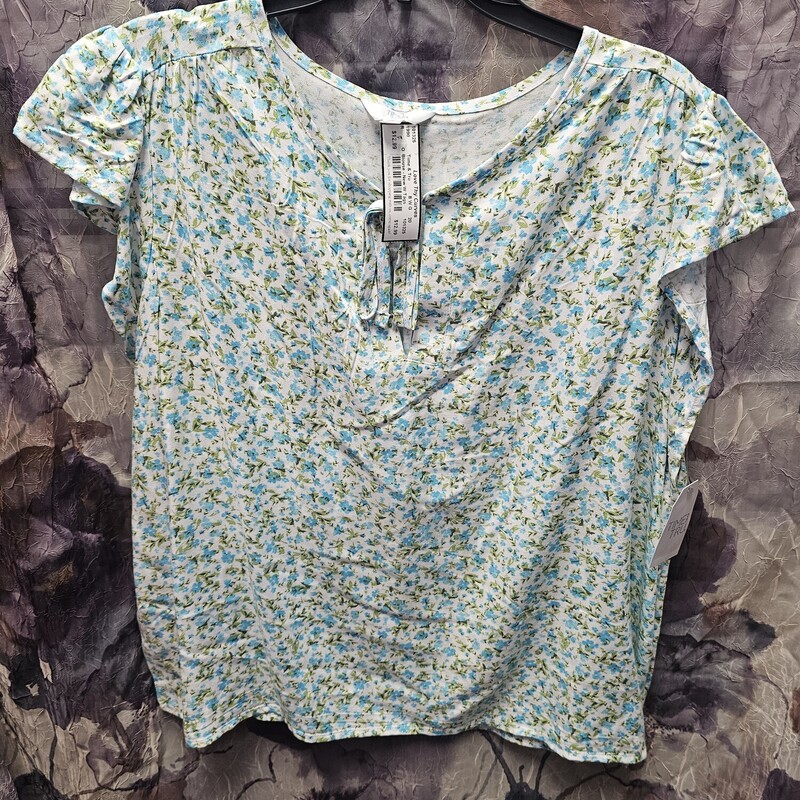 Brand new with tags, this blouse is done in a white with tiny blue and green floral print.