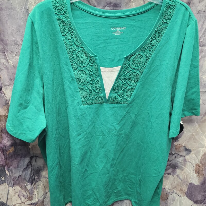 Short sleeve knit top in green with white tank insert panel for coverage and lace embellishments